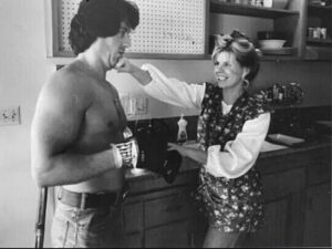 Sasha Czack playfully punching Sylvester Stallone in a candid black and white photo from their early years together